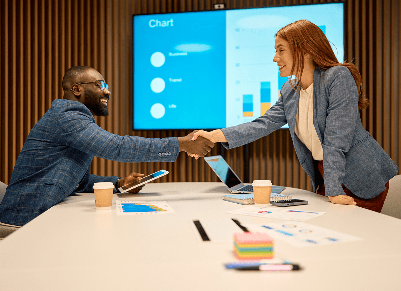 Business meeting handshake in conference room